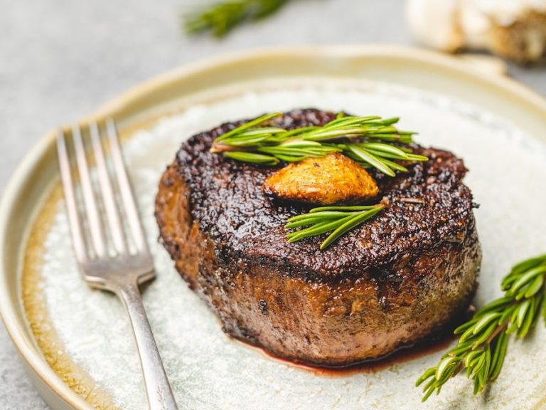 Saftig gebratener Rinderfiletsteak, garniert mit frischen Kräutern und Knoblauch.